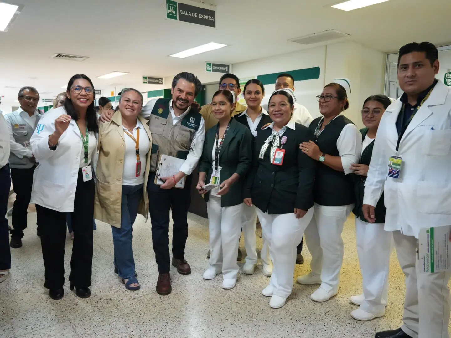 Smiling healthcare staff posing in hospital corridor