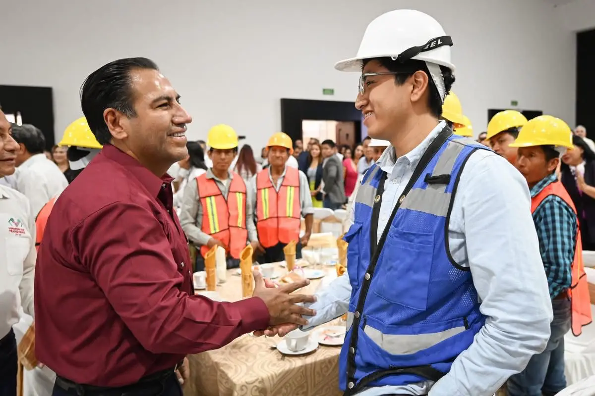 Construction workers shaking hands at safety meeting