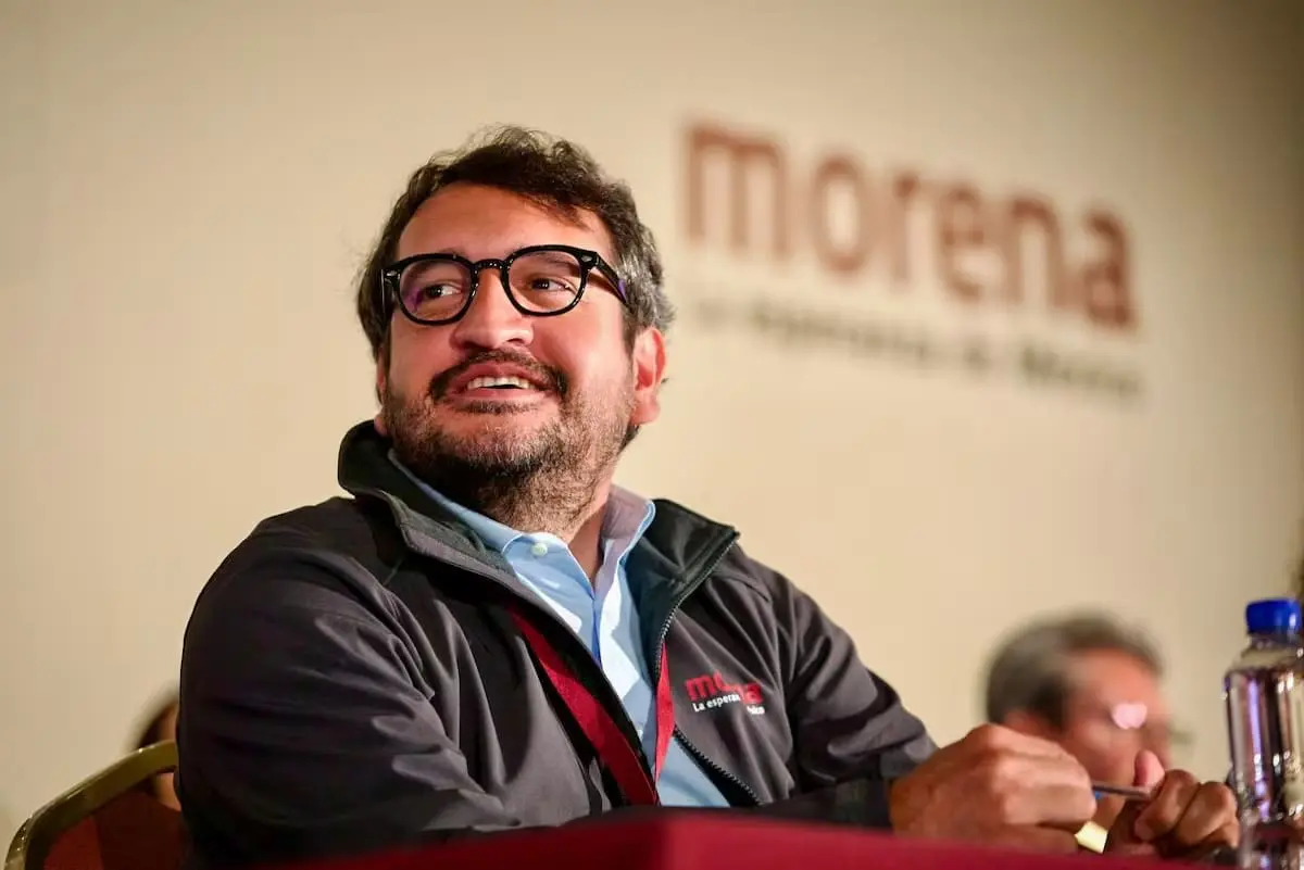 Smiling man with glasses at conference