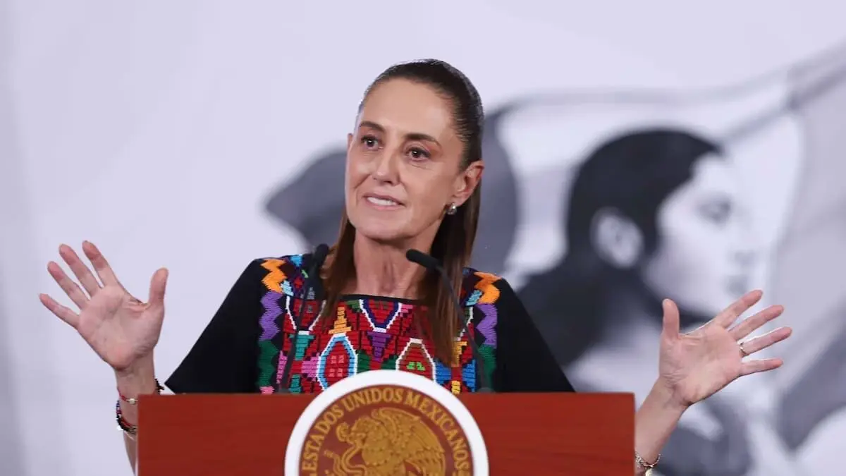 Speaker in embroidered blouse raising hands