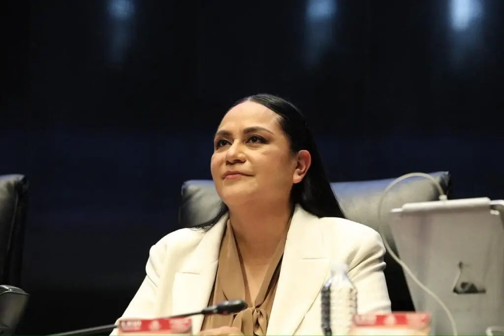 Woman in white blazer at conference table