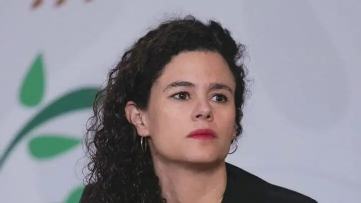 Person with curly hair looking serious