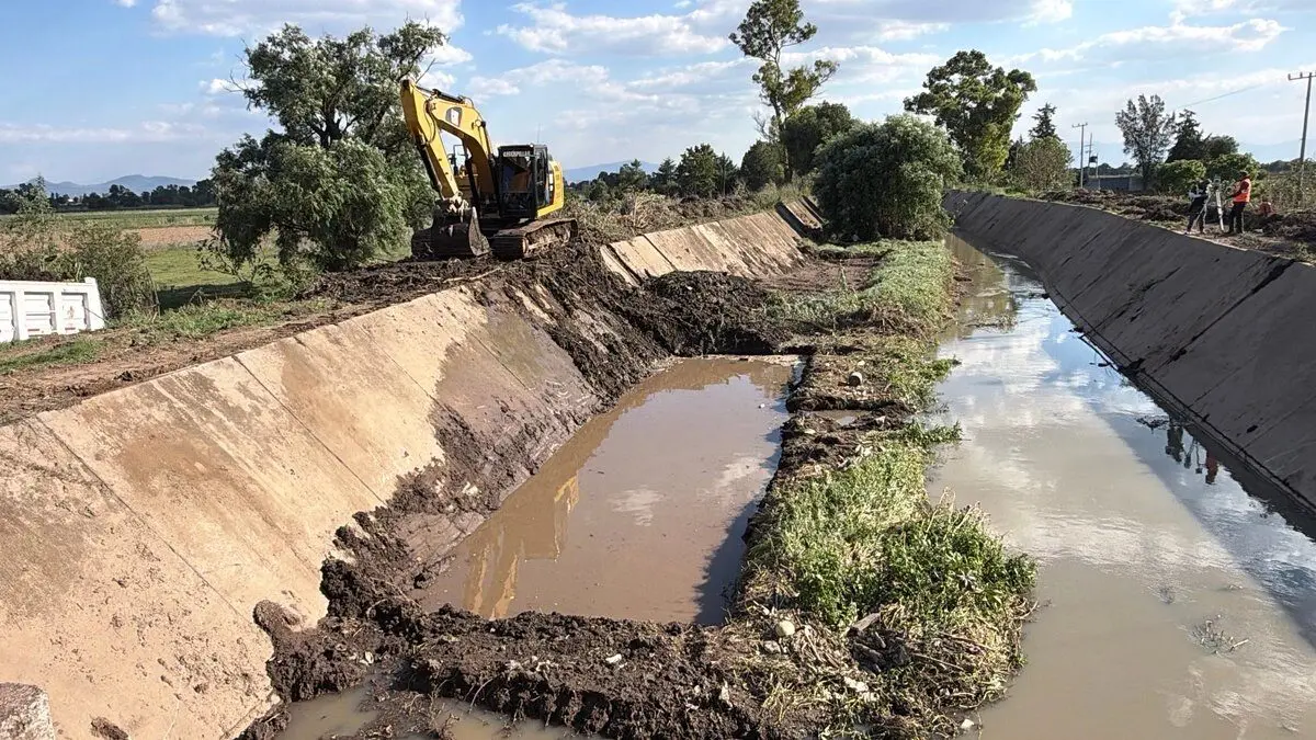 Excavator dredging rural irrigation canal