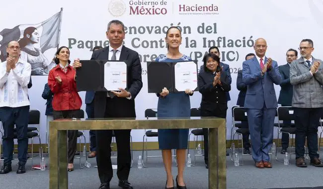 Mexican officials holding signed documents at ceremony
