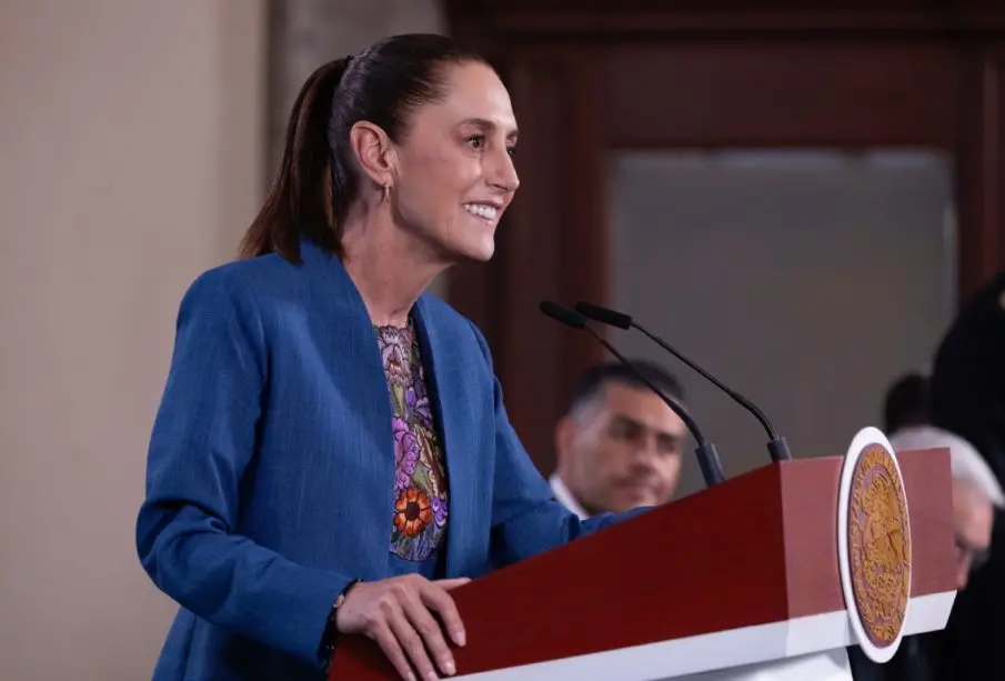 Smiling woman speaking at lectern with seal