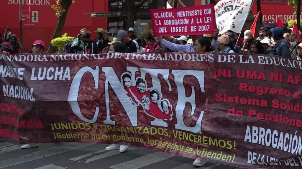 Teachers protesting with large red CNTE banner