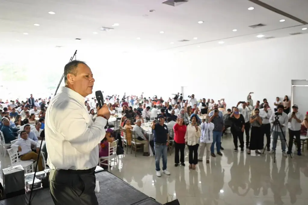 Speaker addressing audience in large conference hall