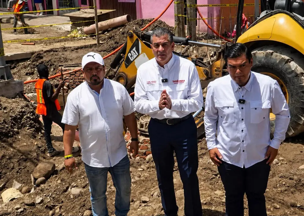 Three men standing at construction site