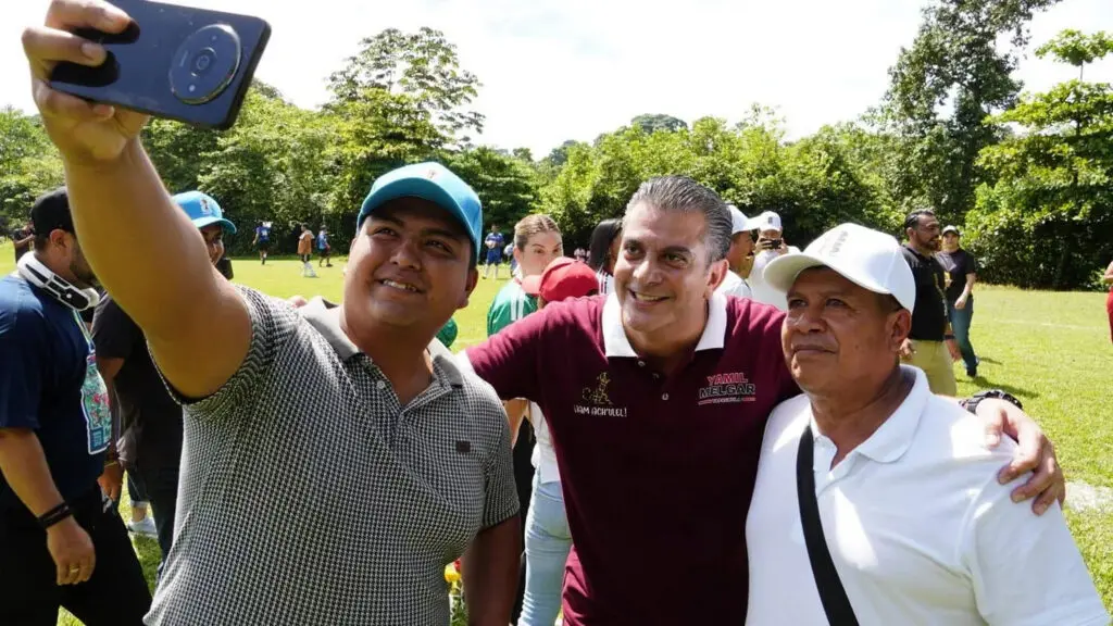 Three men taking selfie in a park