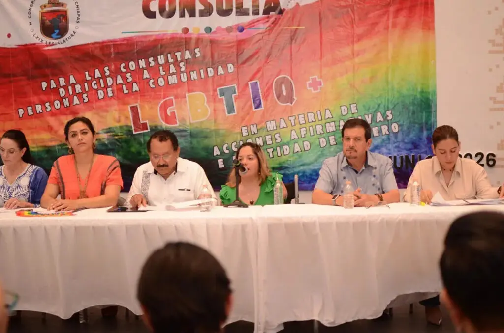 Panel discussion with rainbow LGBTQ+ banner