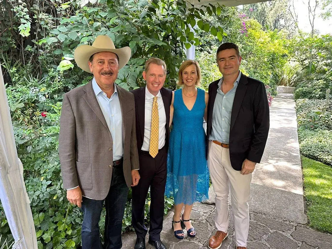 Group of four adults posing in garden
