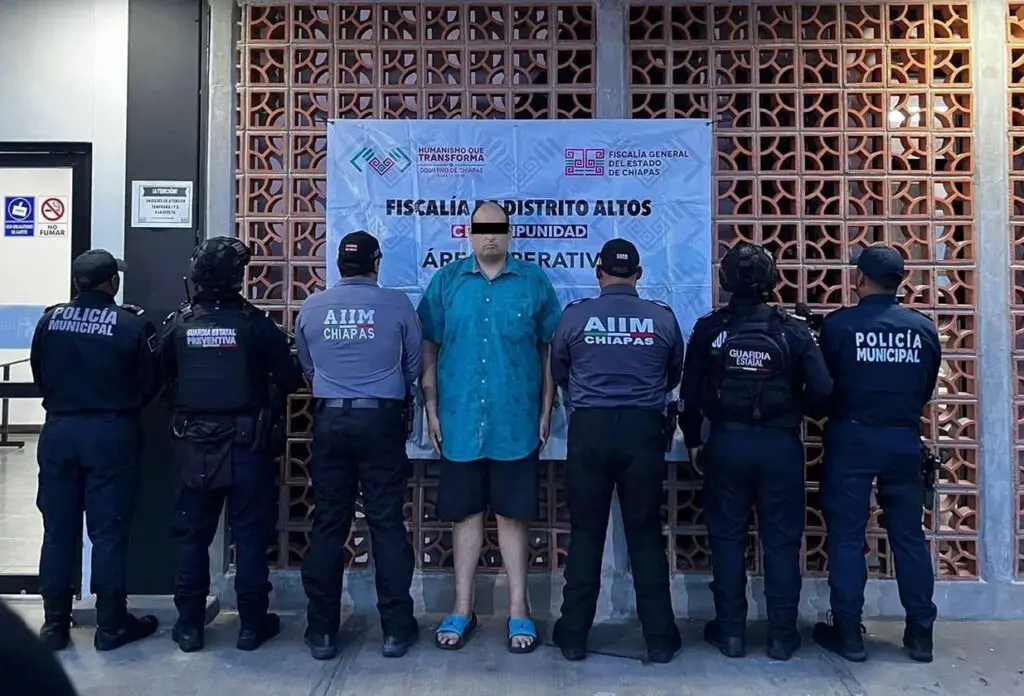 Detained man surrounded by municipal police officers