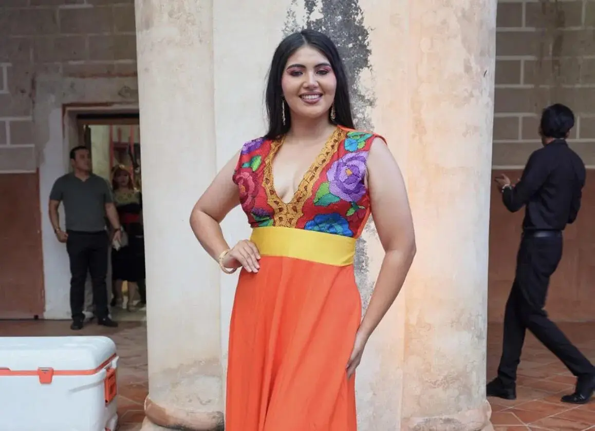 Smiling woman in floral bodice and orange dress