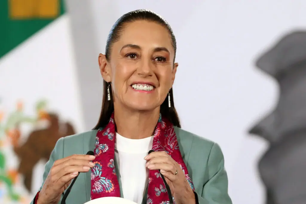 Smiling woman speaking at podium with scarf
