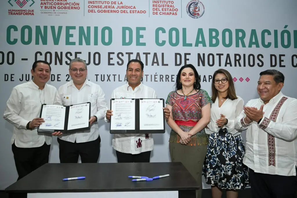 Officials posing with signed cooperation agreement documents