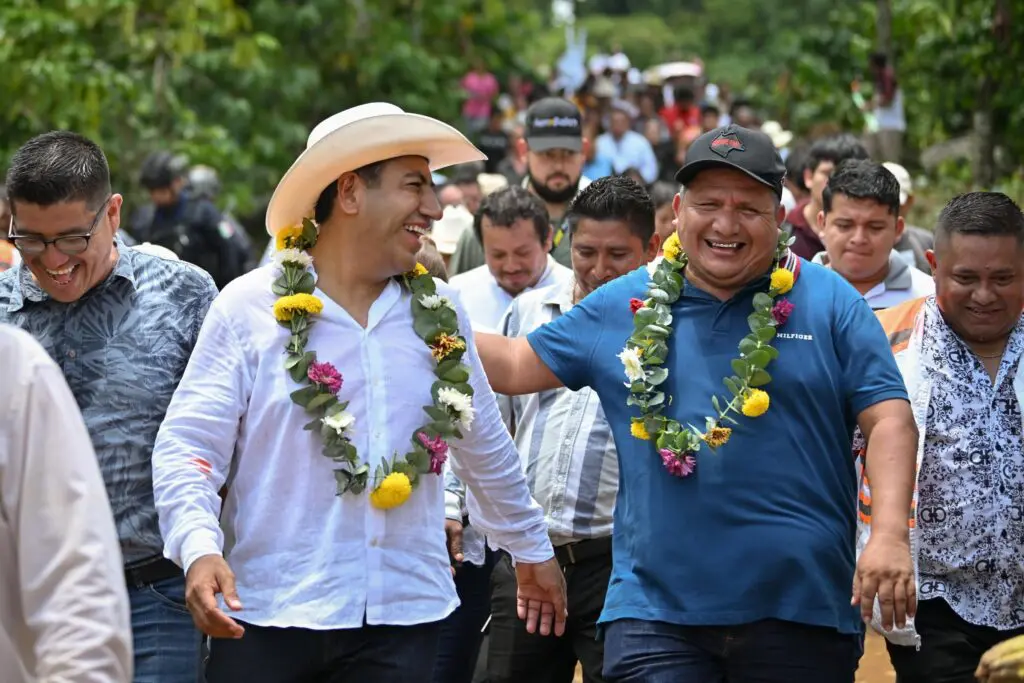 Smiling men outdoors wearing floral garlands