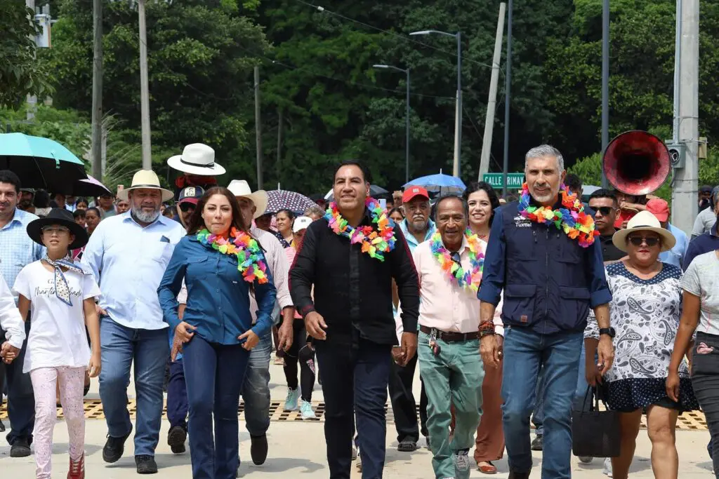People walking in parade wearing colorful leis