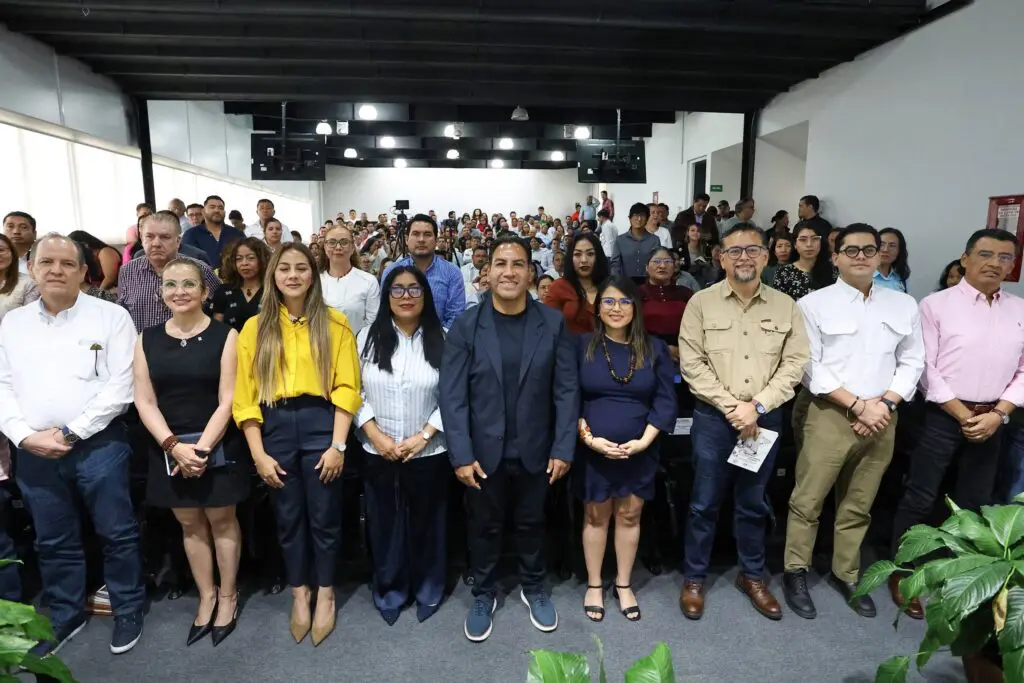 Large group standing together in conference room