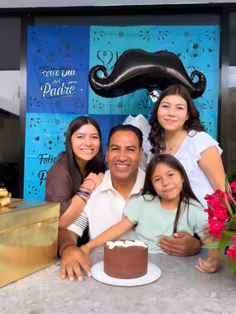 Smiling father with three daughters celebrating