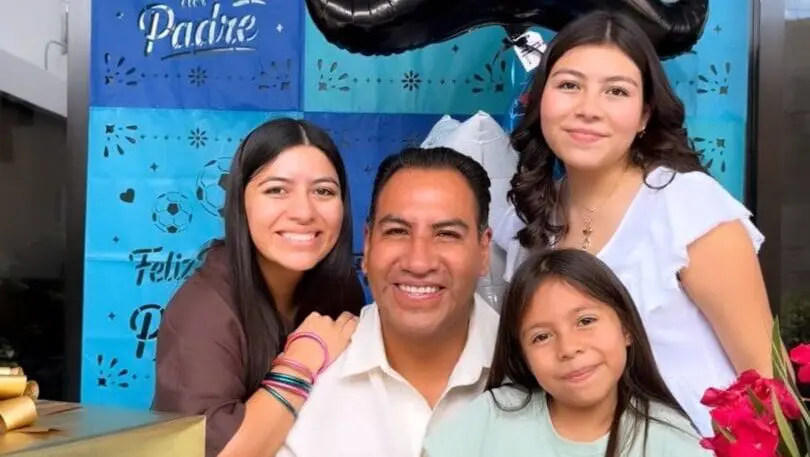 Smiling father with three daughters celebrating