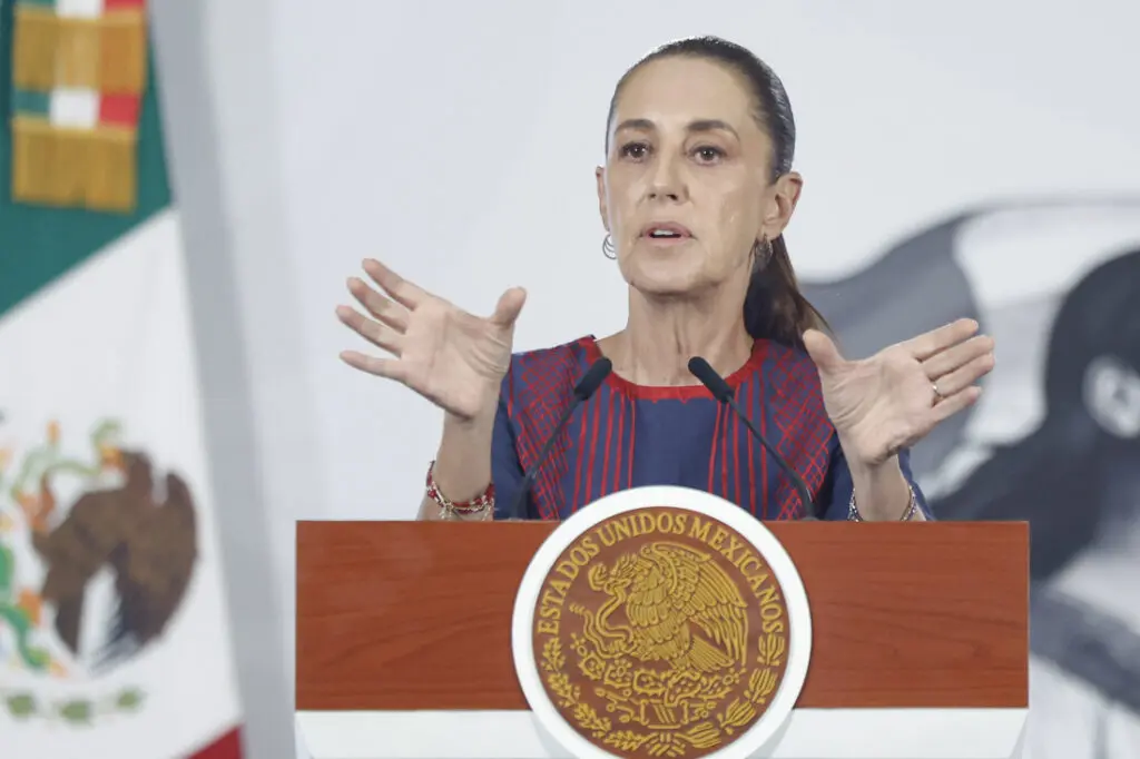 Speaker gesturing broadly behind presidential podium