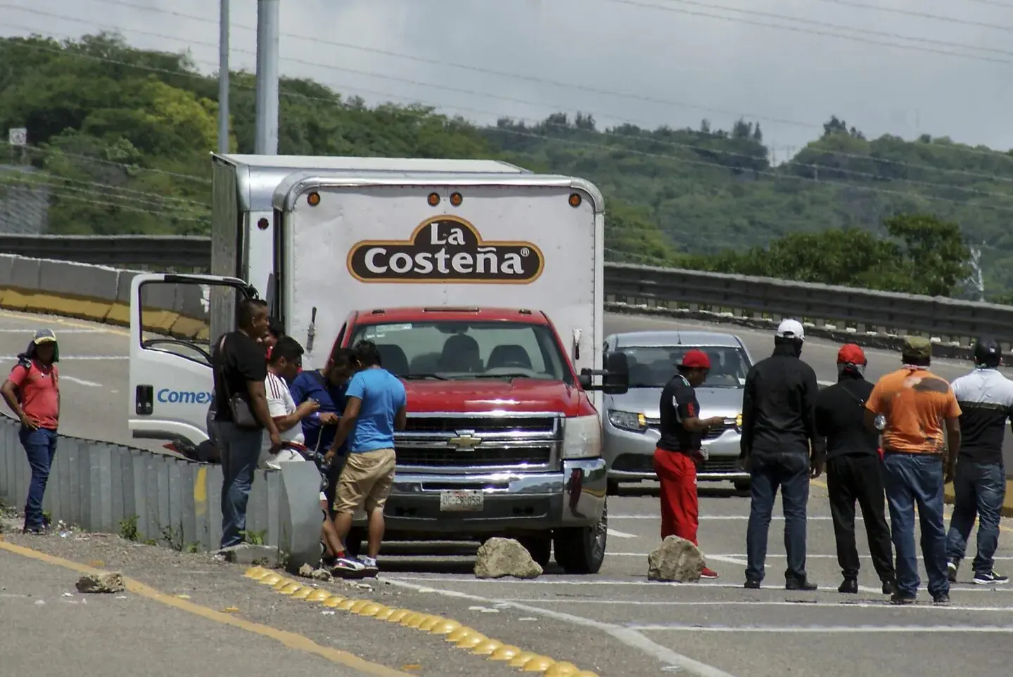 People gathered around La Costeña delivery truck