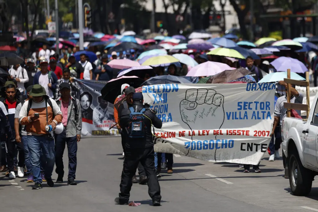 Protest march with banner and umbrellas