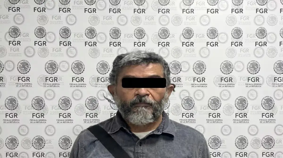 Censored man standing before FGR logo backdrop