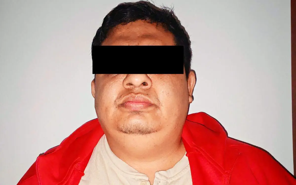 Person with eyes obscured wearing red hoodie