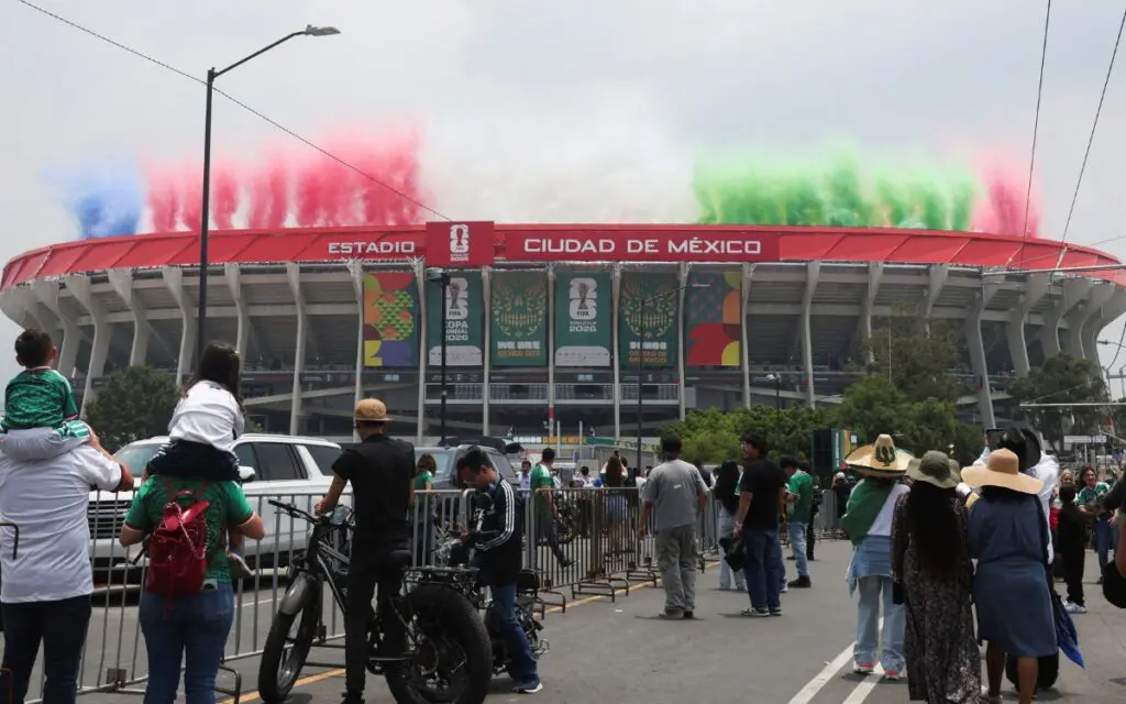 Crowd outside Mexico City stadium with colored smoke