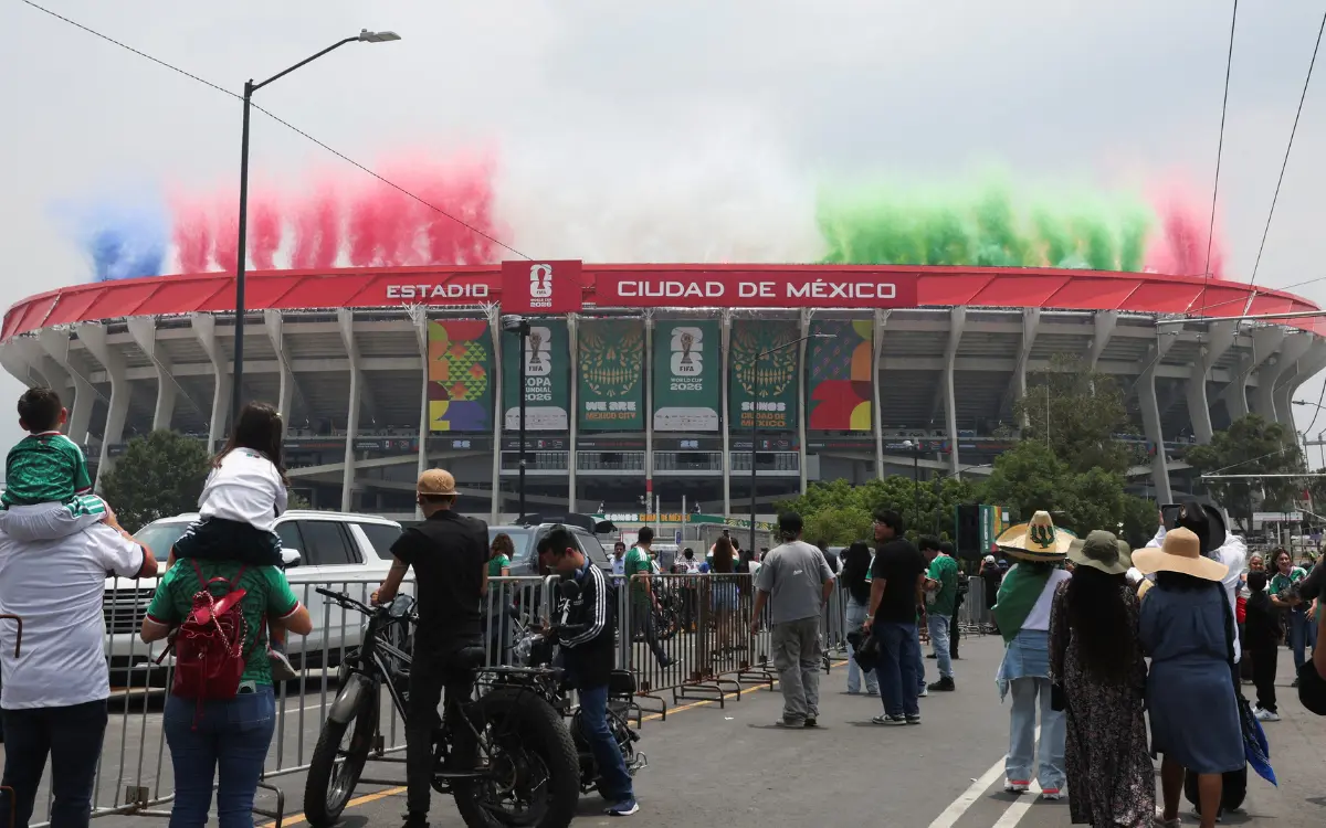 Crowd outside Mexico City stadium with colored smoke