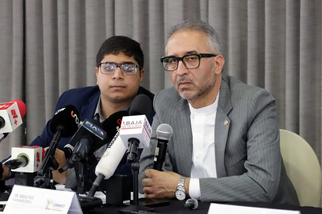 Two men at press conference with microphones
