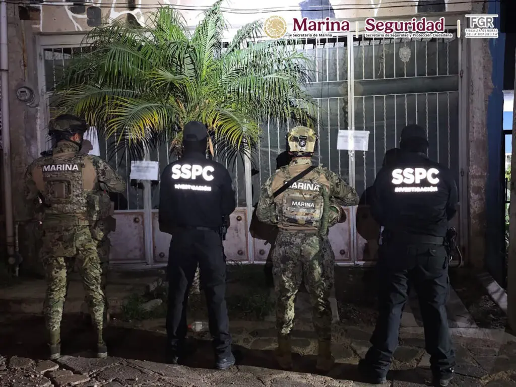 Four uniformed security agents by metal gate