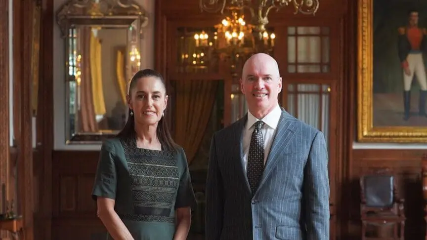 Two people in formal attire in ornate room