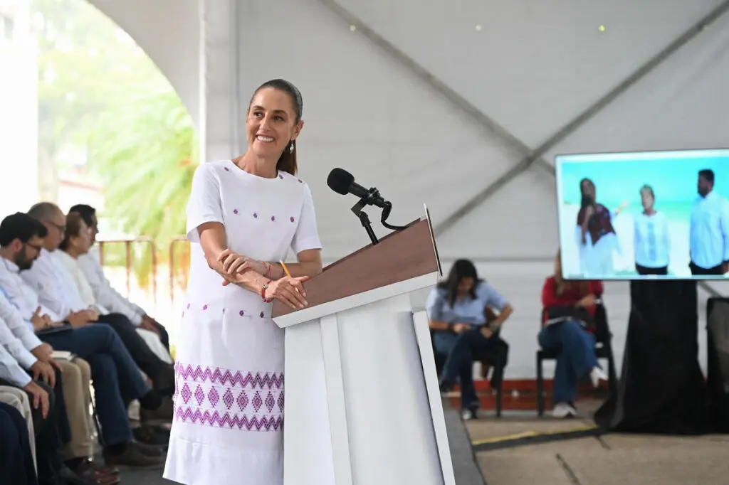 Smiling woman speaking at podium outdoors