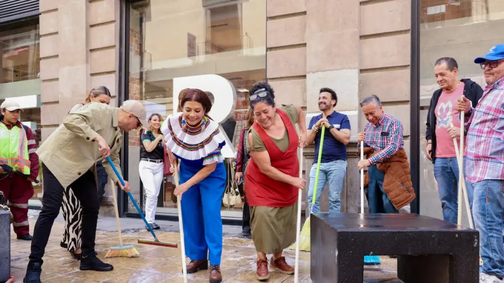 Community volunteers sweeping city street
