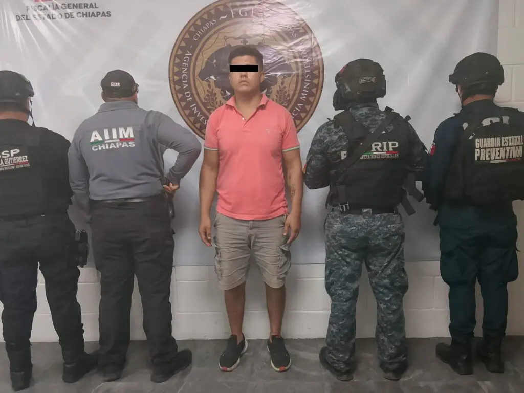 Man standing between uniformed law enforcement officers
