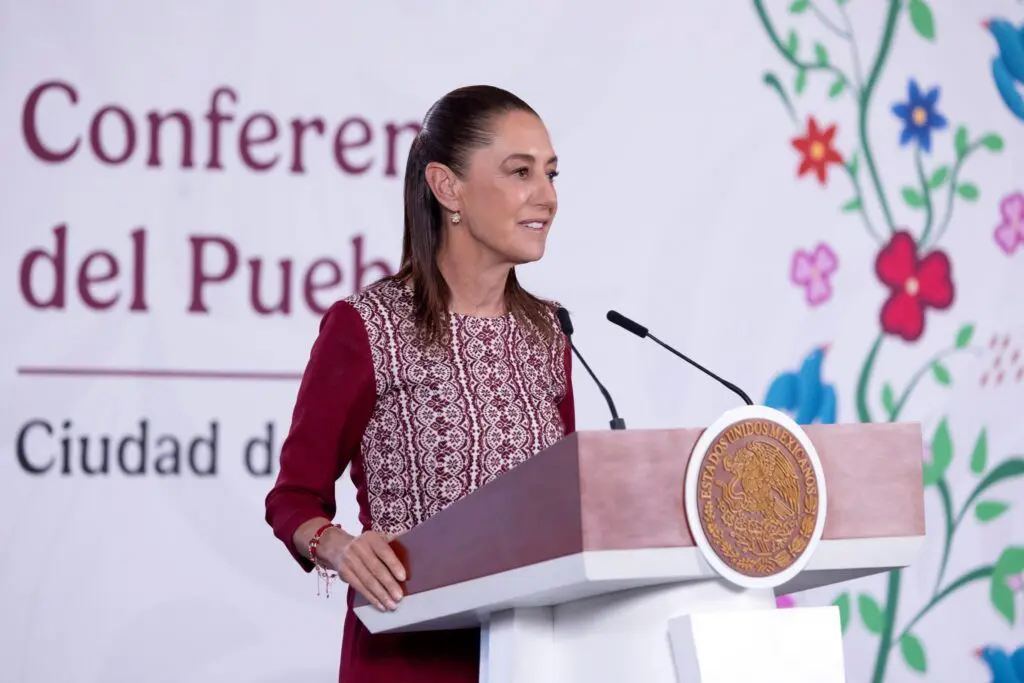 Smiling woman at podium with floral backdrop
