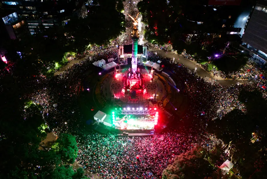 Aerial view of nighttime crowd around illuminated monument