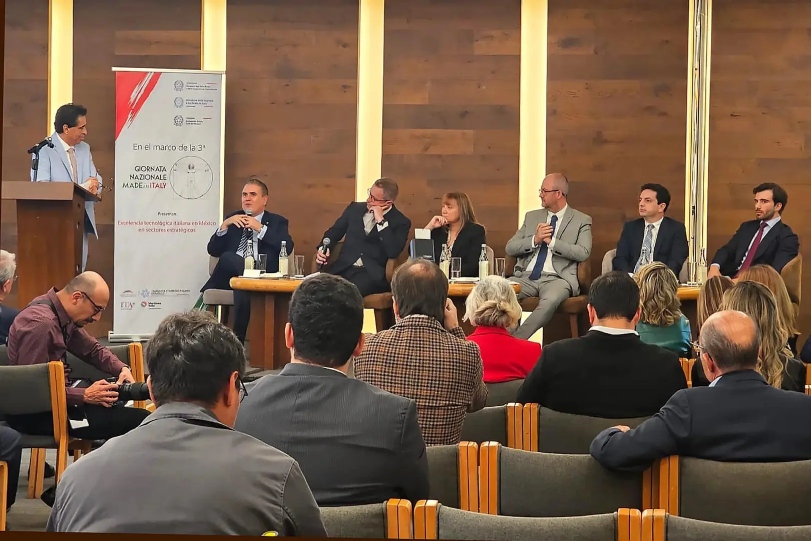 Panel discussion at conference with seated audience