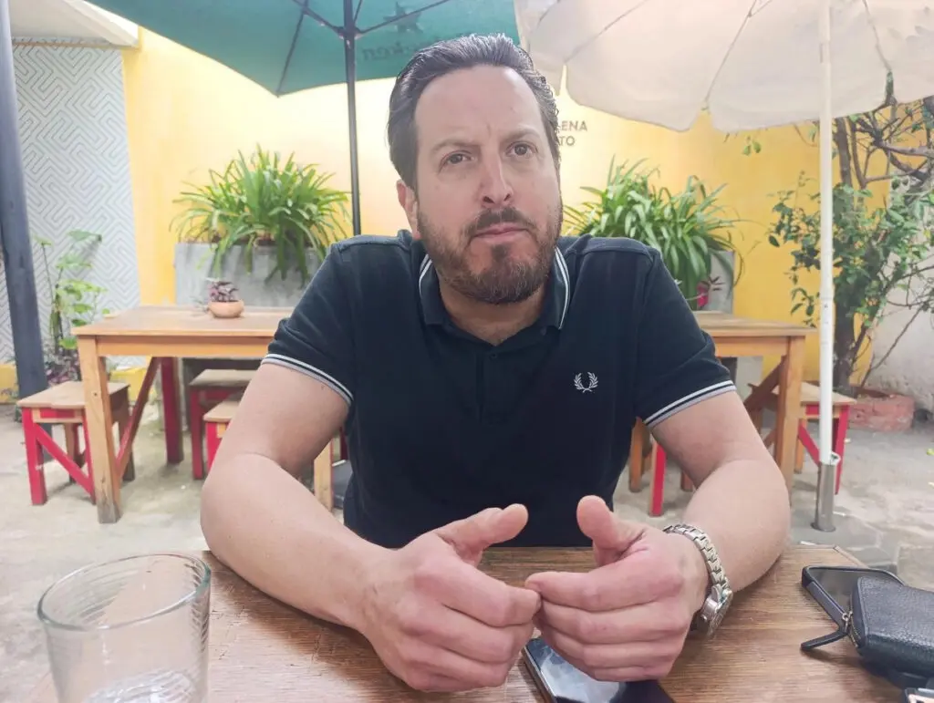 Bearded man sitting at outdoor cafe table