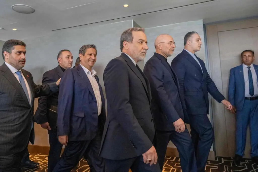 Group of men in suits walking through hallway