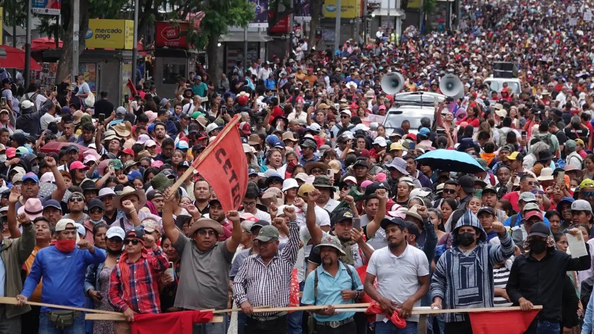 Crowded street protest with banner and megaphones