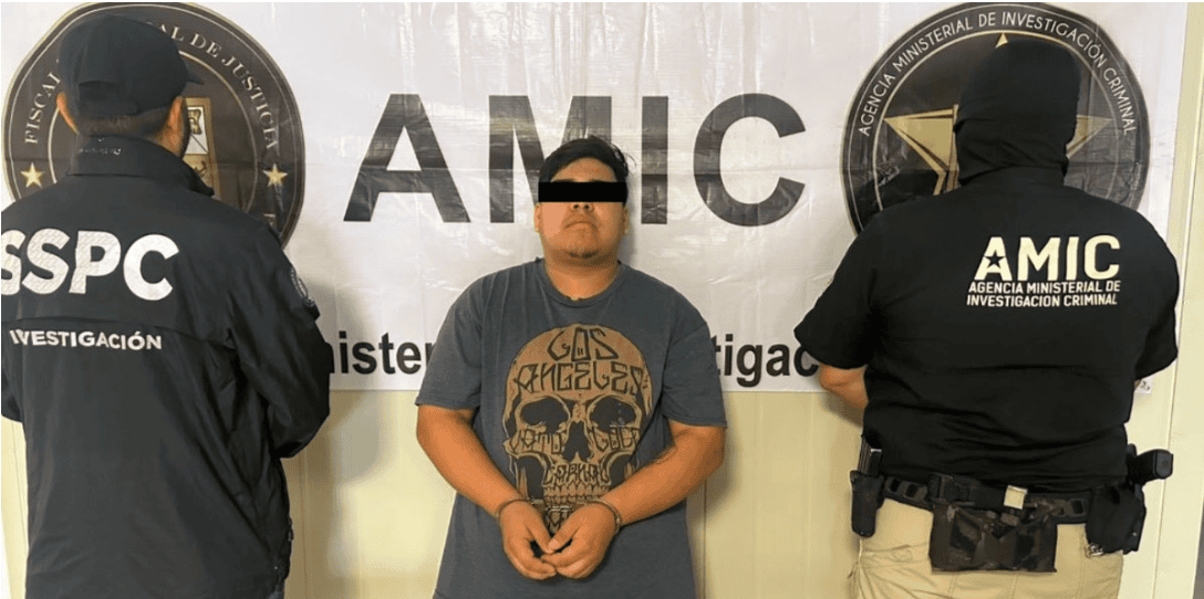 Handcuffed man flanked by two officers
