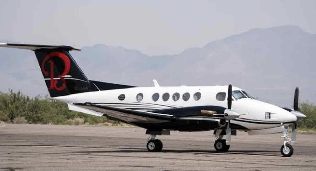 White twin-engine turboprop plane on tarmac