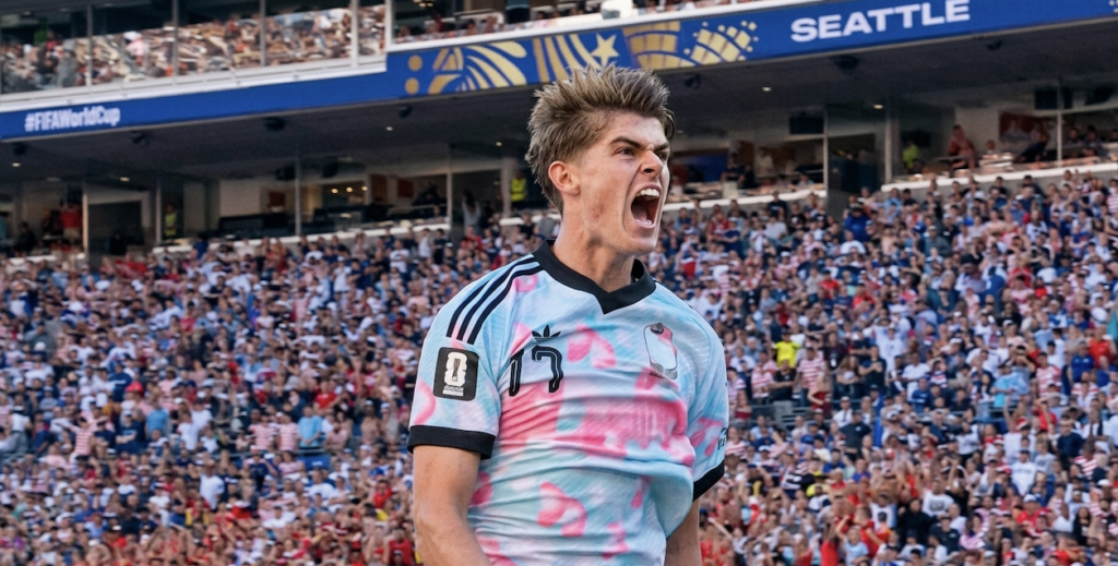 Soccer player shouting amid packed stadium crowd
