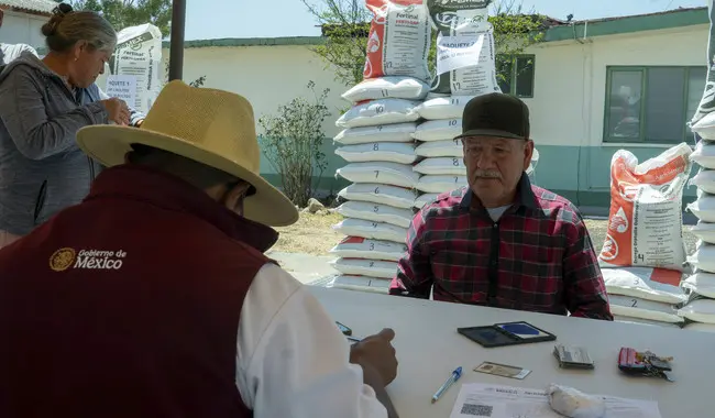Productores reciben apoyos del programa Fertilizantes Bienestar en centro de distribución.