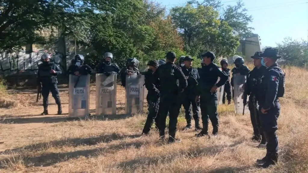 Police officers in tactical gear standing together.