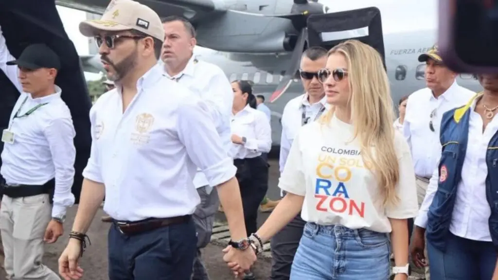 Couple holding hands at a public event.