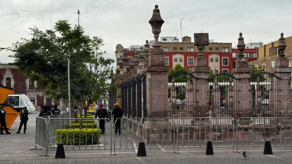 Historic gate with security barriers in view.